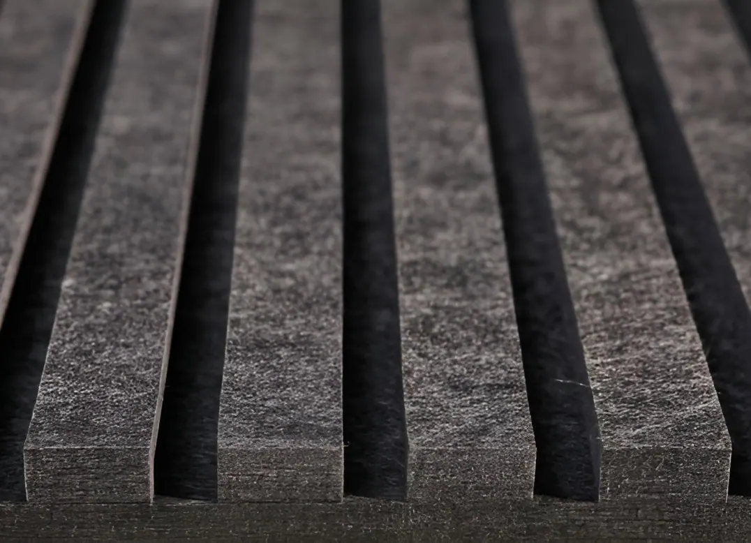 Close-up of an rPET Groove acoustic panel in grey recycled PET felt, showing the grooves and the felt edge
